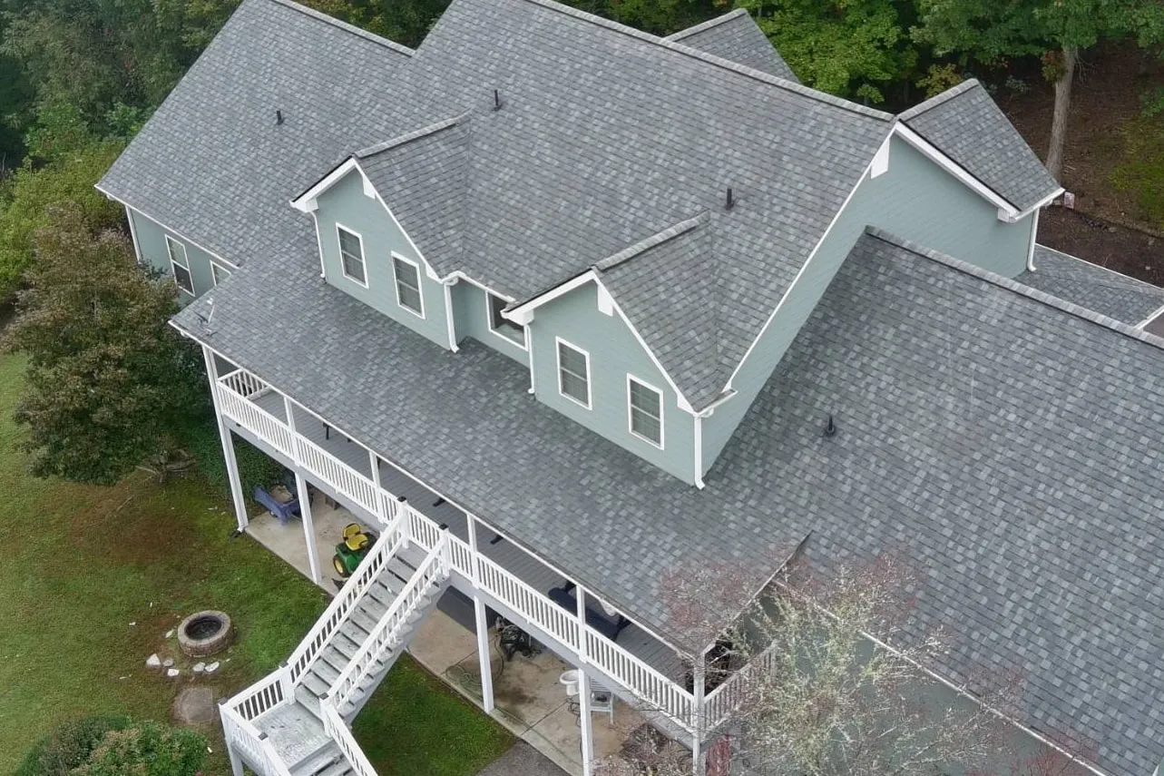 Drone view of the same home after Iron Ridge installed a new gray shingle roof