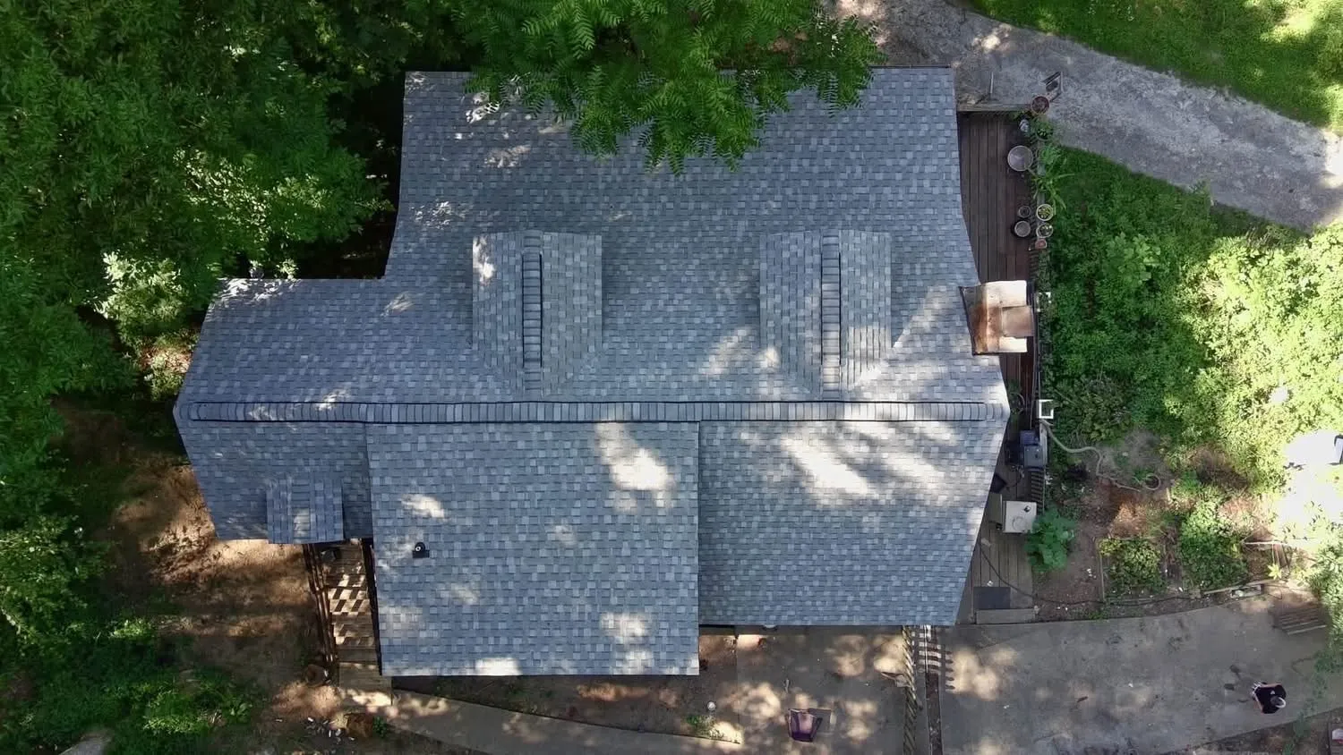 Top-down drone view of the same home after Iron Ridge installed a new gray architectural shingle roof