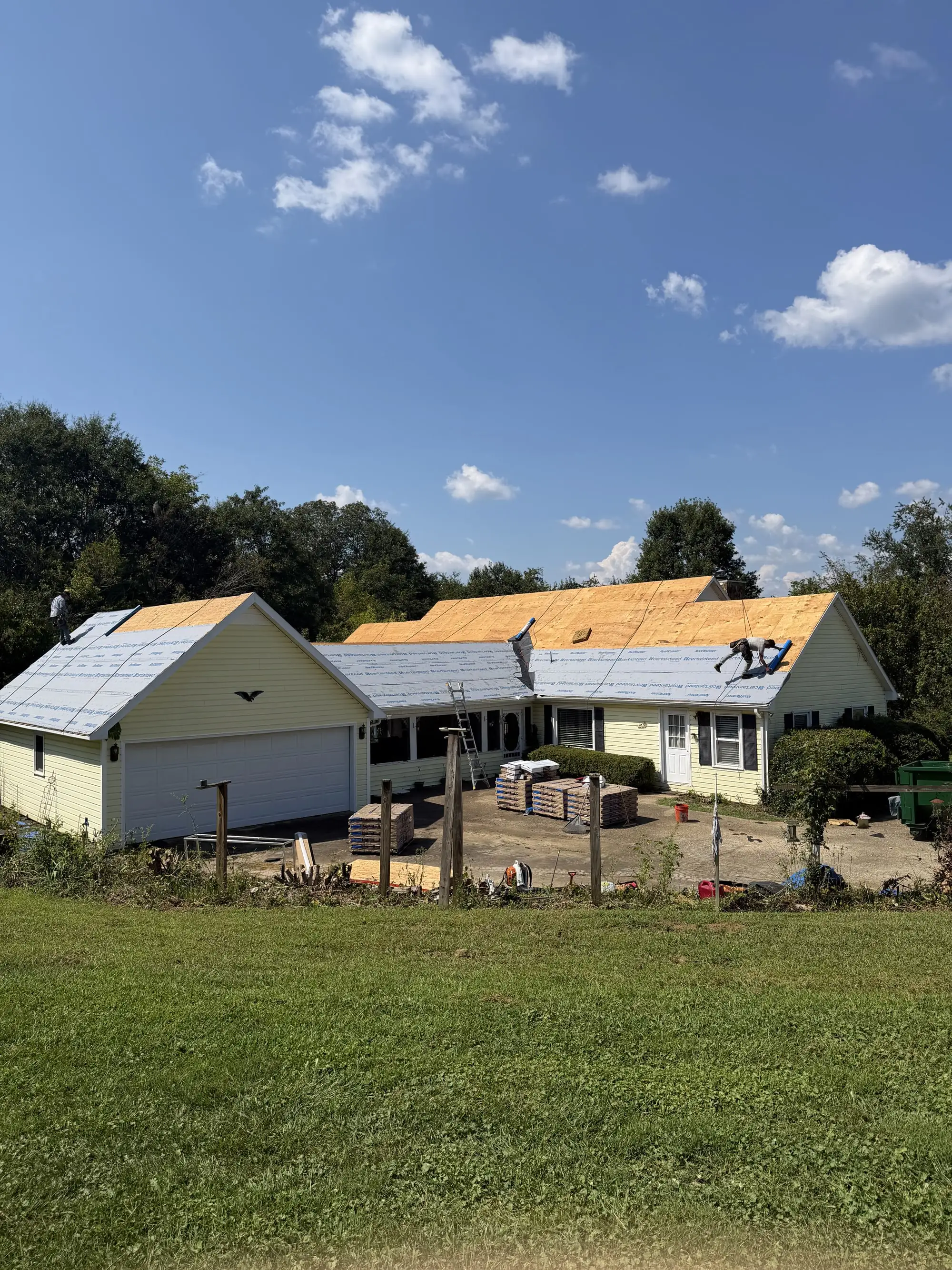 Iron Ridge crew installing new decking and underlayment on a ranch-style home
