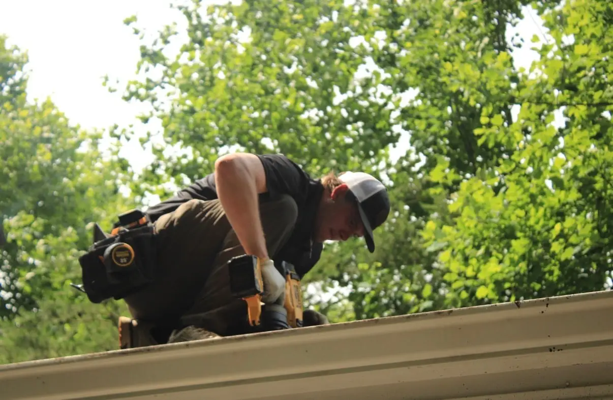 Logan, owner of Iron Ridge Roofing, working on a roof