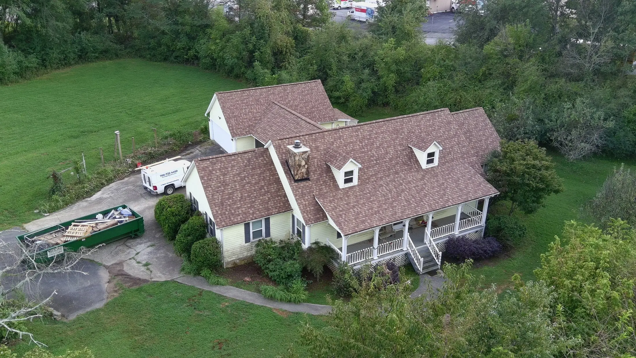Home with a new brown architectural shingle roof installed by Iron Ridge Roofing