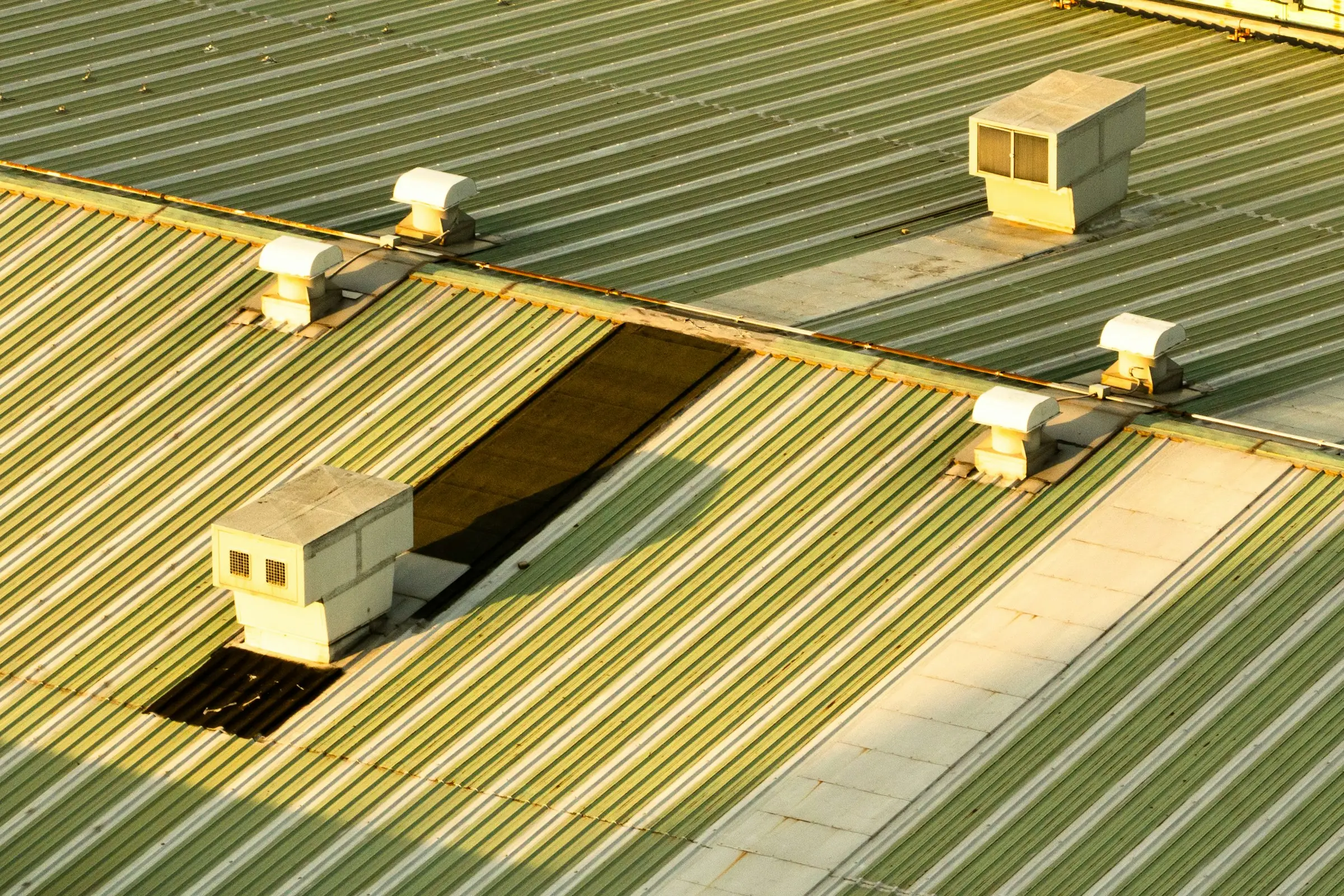 Corrugated metal commercial roof with rooftop HVAC units