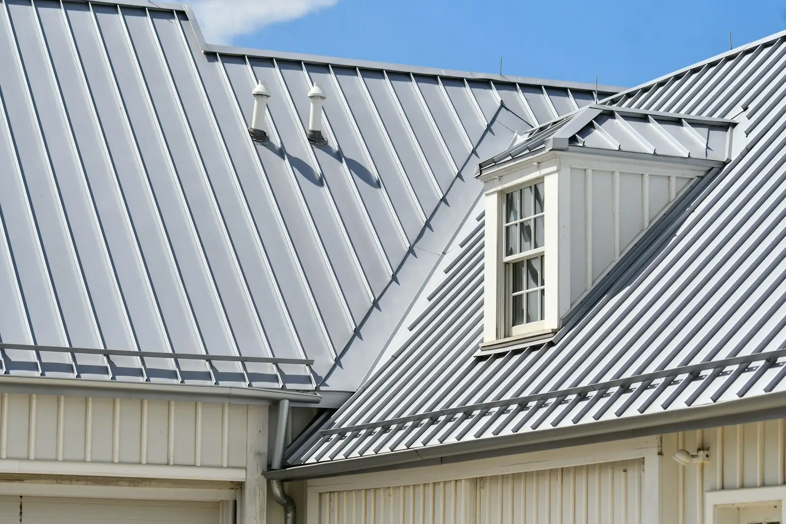 Standing seam metal roof with a dormer, showing raised seams and no visible screws